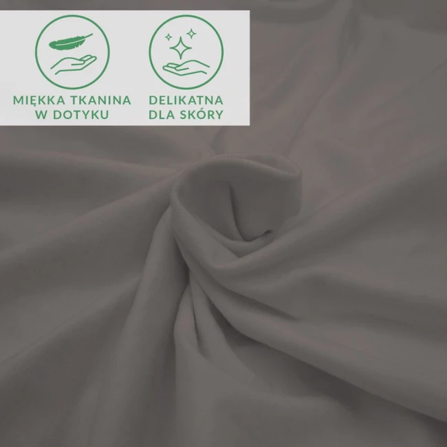 Prześcieradło jersey z elastanem w kolorze antracyt, wykonane z miękkiego materiału. Widać jego gładką teksturę, rozłożone na płaszczyźnie, z widocznymi symbolami informującymi o delikatności tkaniny dla skóry.