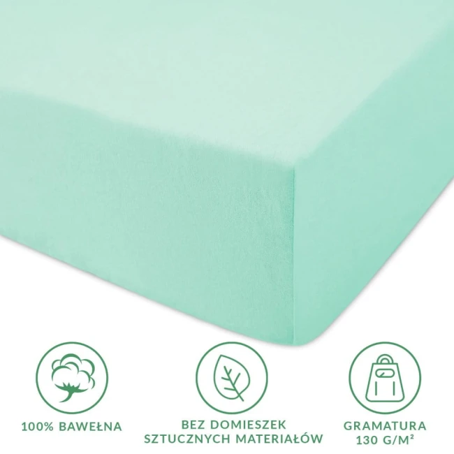 Prześcieradło jersey z gumką 180x200 w kolorze morskim, wykonane w 100% z bawełny. Produkt leży na neutralnym tle, pokazując jego gładką fakturę oraz mocne gumki. Widoczne ikony informujące o braku domieszek sztucznych materiałów i gramaturze 130 g/m².