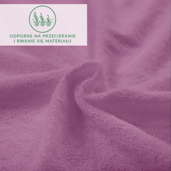 Prześcieradło frotte z gumką w jasnym fioletowym kolorze, o miękkiej, teksturowanej powierzchni. Ujęcie z bliska, ukazujące falujące tkaninę, która jest odporna na przecieranie i rwanie, idealne do łóżka o wymiarach 90x200 cm.