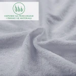 Prześcieradło frotte 120x200 w kolorze popielatym, z gumką, rozłożone na gładkiej powierzchni. Materiał delikatny, teksturowany, odporny na przecieranie.