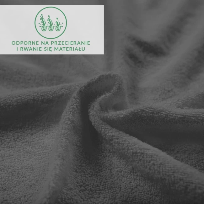 Prześcieradło frotte z gumką 140x200 w kolorze antracytowym, o teksturowanej powierzchni, leżące na gładkiej nawierzchni. Widać detale materiału, podkreślające jego miękkość. Na górze umieszczona informacja o odporności na przetarcia.