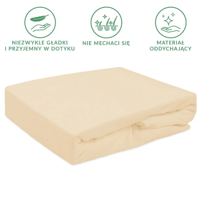 Prześcieradło frotte z gumką 120x200 w kolorze jasnym beżu, leżące płasko, z wyraźną fakturą, wykonaną z materiału oddychającego, z logo i informacjami na tkaninie. Ujęcie z góry, na prostym tle.