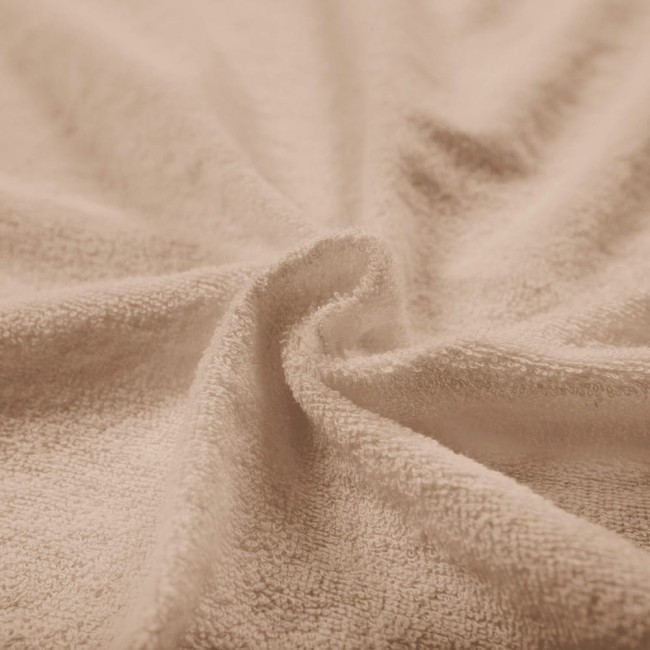 Pościel frotte w kolorze beżowym, rozłożona na miękkiej powierzchni. Widoczna struktura materiału z wyraźną teksturą frotte, w drobnym zbliżeniu, podkreślająca miękkość i komfort. Idealna do aranżacji sypialni.