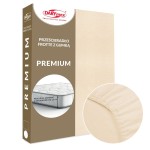 Prześcieradło frotte z gumką w jasnym beżu o wymiarach 90x200 cm. Produkt w opakowaniu z informacją o pasowaniu na materac o wysokości do 25 cm. Zbliżenie na gumkę, która zapewnia stabilność. Tło w jednolitym kolorze.